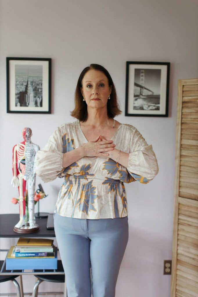 Four Energy Gates Qigong practice with hands over the heart center